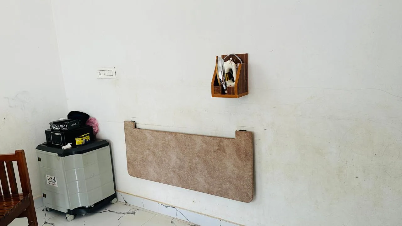 Brown iron table folded flat against a wall