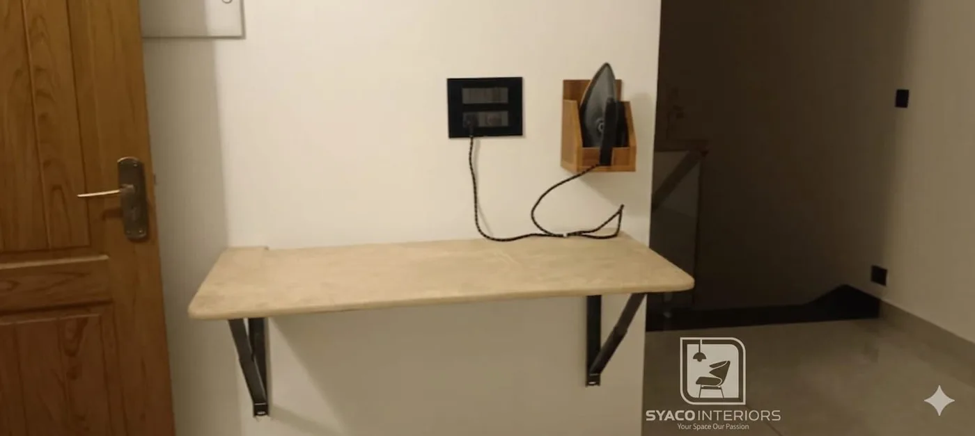 Beige foldable iron table open next to a bedroom door